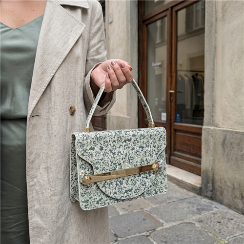 Tory Burch Queen Anne Lace floral leather top handle handbag with cream botanical print and golden hardware, styled for afternoon tea, garden parties, and elegant daytime occasions.