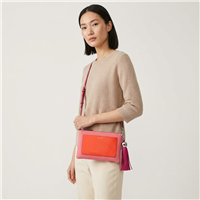 Tory Burch Bright Azalea pink leather convertible crossbody clutch with coral red colorblock front pocket, slim strap, polished metal hardware and oversized pink leather tasse