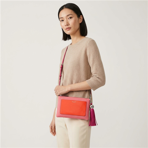 Tory Burch Bright Azalea pink leather convertible crossbody clutch with coral red colorblock front pocket, slim strap, polished metal hardware and oversized pink leather tasse