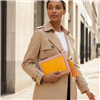 Tory Burch blush pink leather convertible crossbody clutch with marigold yellow front pocket, matching long tassel, slim shoulder strap and polished metal hardware.