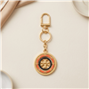 Tory Burch rotating Geo logo key fob bag charm with multicolor circular geometric design, spinning center T logo, gold tone clip, chain, and split key ring.