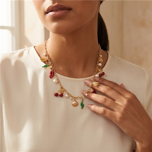 Tory Burch gold tone 21.5 inch chain necklace with colorful cactus, banana, seashell, cherry, red lips, T medallion and simulated pearl charms.