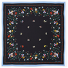 Tory Burch black silk square scarf with multicolor floral and botanical print, red and green accents, and contrasting soft blue border, styled as a neckerchief.