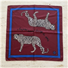 Tory Burch 21 inch burgundy silk square scarf with two black and white spotted leopards, A Leopard Never Changes Its Spots text, blue border, and logo motif.