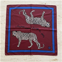 Tory Burch 21 inch burgundy silk square scarf with two black and white spotted leopards, A Leopard Never Changes Its Spots text, blue border, and logo motif.