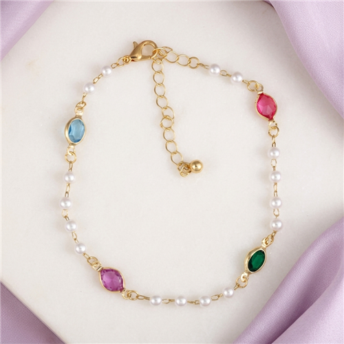 Zad Jewelry Ocean Treasure gold tone anklet featuring white pearl inspired beads and faceted aqua blue, emerald green, pink, and fuchsia jewel accents with adjustable extender chain.