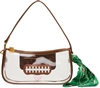 Betsey Johnson Miss Touchdown clear football shoulder bag featuring brown trim, football lace detail, structured transparent body, brown shoulder handle, and green printed scarf accent.