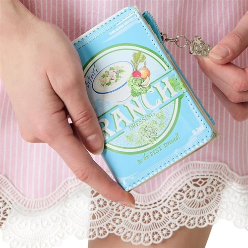 Betsey Johnson Dip It folding wallet designed like a light blue ranch dressing package with green graphics, illustrated vegetables, creamy dip artwork, and retro food label details.
