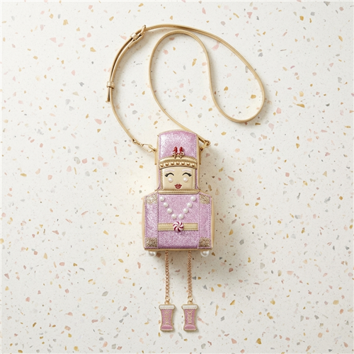 Betsey Johnson pink rhinestone Nutcracker novelty crossbody handbag with gold tone trim, faux pearl accents, peppermint detail and dangling chain legs with pink boots.