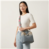 Betsey Johnson Denim Bucket Bag featuring faded blue and neutral ombre coloring, silver tone hardware, short top handle, and a wide adjustable strap with pink and yellow floral details.
