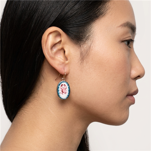 Zad Jewelry Bay oval drop earrings featuring pink crab illustrations on white enamel centers with blue borders and gold tone fish hook ear wires.