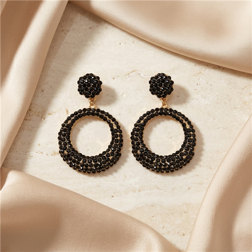 Amrita Singh Broadway 2.5 inch circular drop earrings featuring jet black Austrian crystals covering round stud tops and open circle drops with gold tone metal accents.