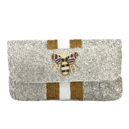 Fashion Culture silver and white beaded clutch featuring a queen bee motif, metallic gold stripe accents, snap flap closure, lined interior, and removable chain crossbody strap.
