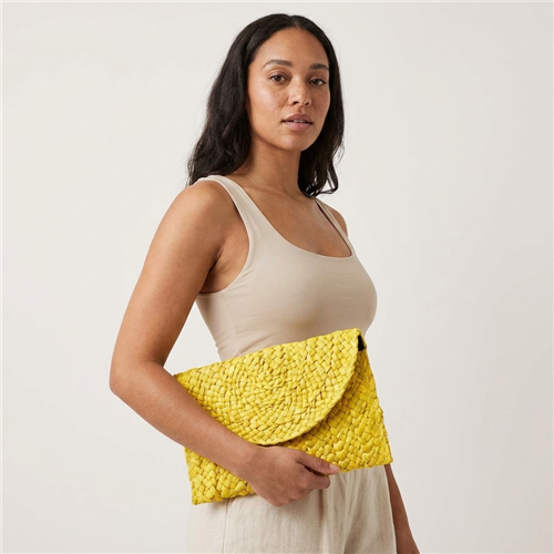 Fashion Culture woven crochet straw envelope clutch handbag with flap snap closure and slim lined silhouette in vibrant resort inspired colors for vacation and summer styling.