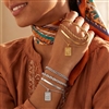 Layered mixed chain bracelet set with rope, snake, link, and delicate chain designs plus a rectangular portrait coin inspired charm, available in gold tone and silver tone.