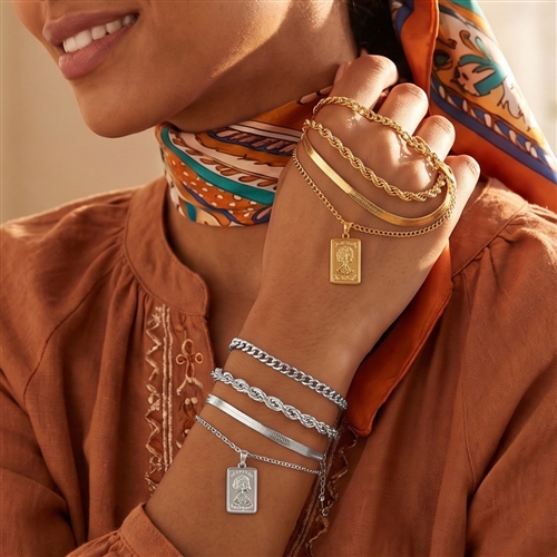 Layered mixed chain bracelet set with rope, snake, link, and delicate chain designs plus a rectangular portrait coin inspired charm, available in gold tone and silver tone.