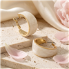 The Bagtique Jewelry Collection wide hoop earrings featuring creamy white acrylic panels framed in polished gold tone metal with a compact chunky curved silhouette.