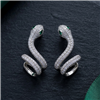 Silver tone crystal snake wrap statement ring with a sculptural coiled serpent design, clear sparkling crystals, and emerald green eye accents.