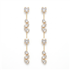 Long gold tone crystal cascade drop earrings with round, teardrop, and marquise inspired clear crystals in an elegant 3.75 inch linear silhouette.