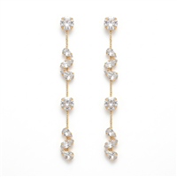 Long gold tone crystal cascade drop earrings with round, teardrop, and marquise inspired clear crystals in an elegant 3.75 inch linear silhouette.
