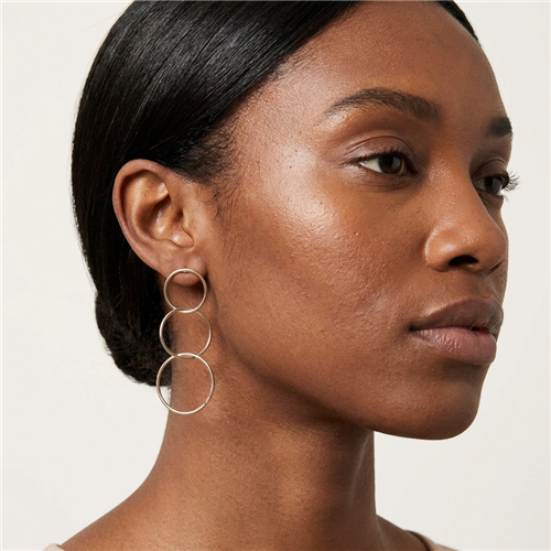 Ann gold tone interlocking triple hoop drop earrings with three graduated open circles and a modern 3 inch geometric silhouette.
