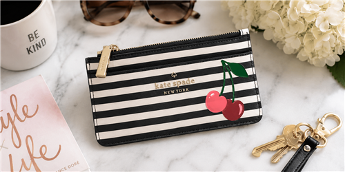 Kate Spade Bing Cherries slim card holder wallet in navy and cream striped saffiano PVC featuring cherry appliquÃ© details, seven card slots, zip coin compartment, and signature logo hardware.
