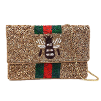 Gold multi mini clutch crossbody bag with a beaded front, dimensional black and white bee motif, green and red vertical stripes, foldover silhouette, and removable gold tone chain strap.