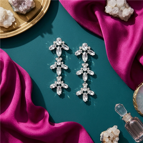Kate Spade Ice Queen Crystal Chandelier Earrings silver tone linear drop earrings with cascading clear marquise and oval shaped crystals arranged in floral inspired clusters.
