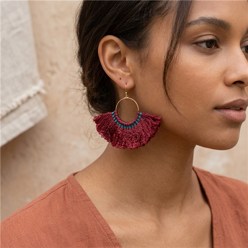 Nakamol Maxi Hoop Tassel Earrings with gold tone hoops, contrasting wrapped thread trim and wide fan shaped flowing fringe, shown in multiple color variations including brown, gray and red.