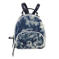 Kate Spade tie dye denim backpack with leather trim, front zip pocket, signature emblem, top handle, and adjustable backpack straps.